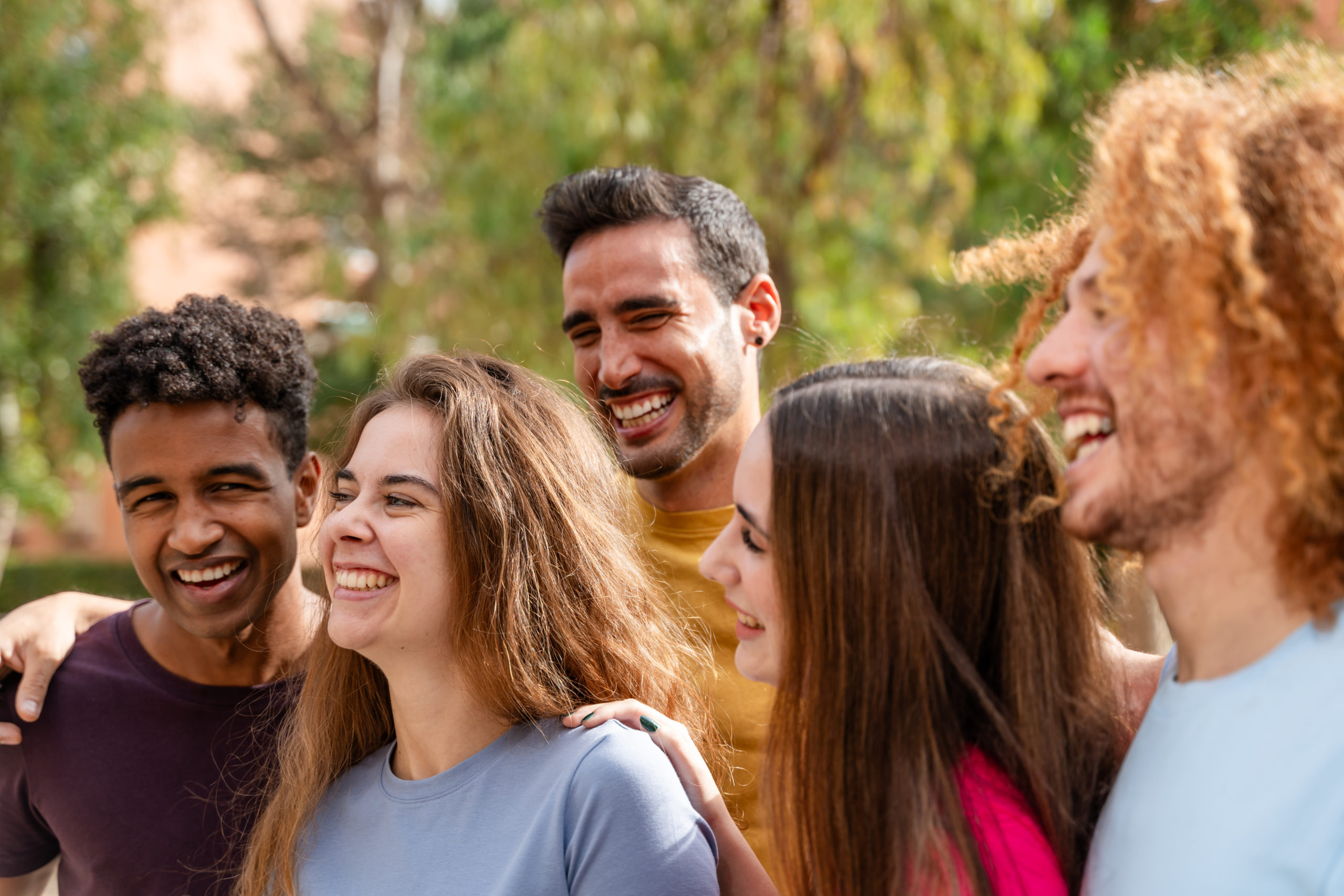 Group of friends having fun outdoors Cheerful young people smiling and looking at camera Friendship concept