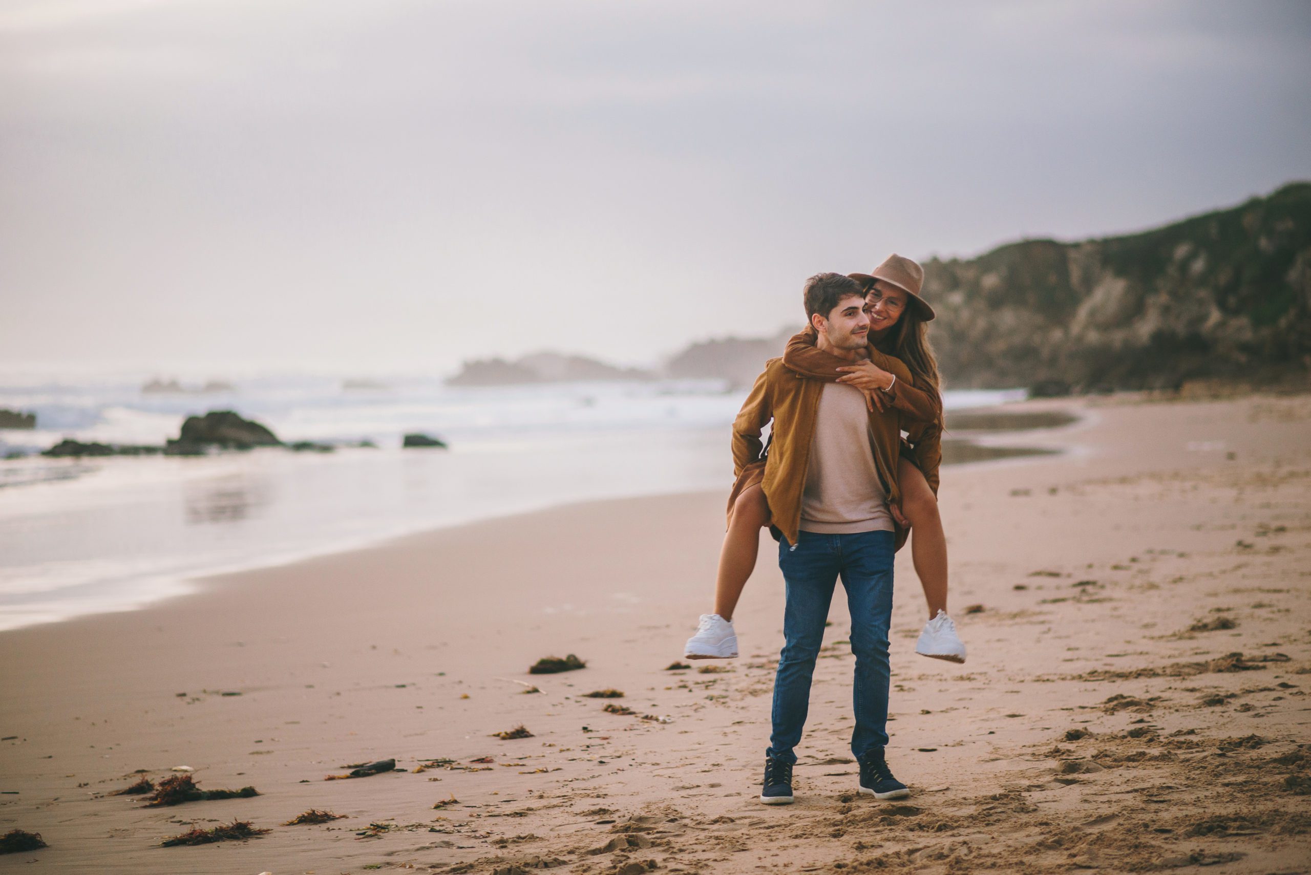 Young couple walking piggyback