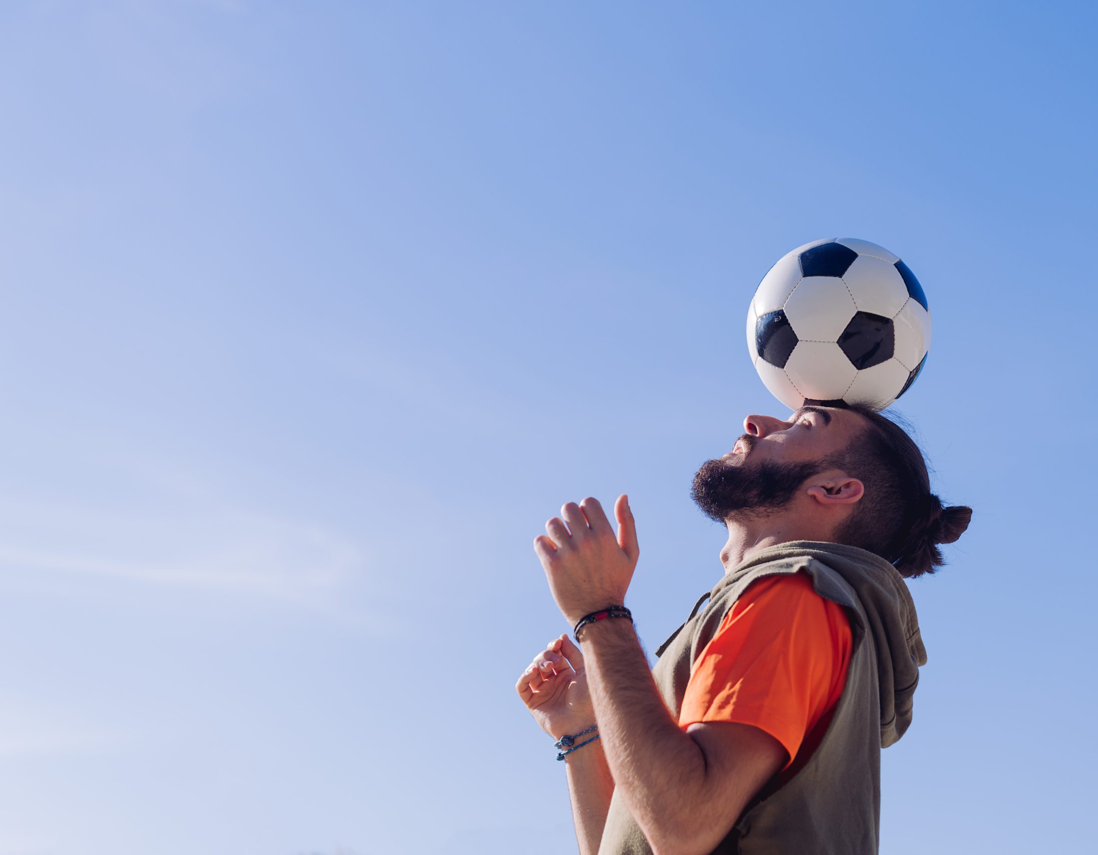 football player balancing the ball on his head