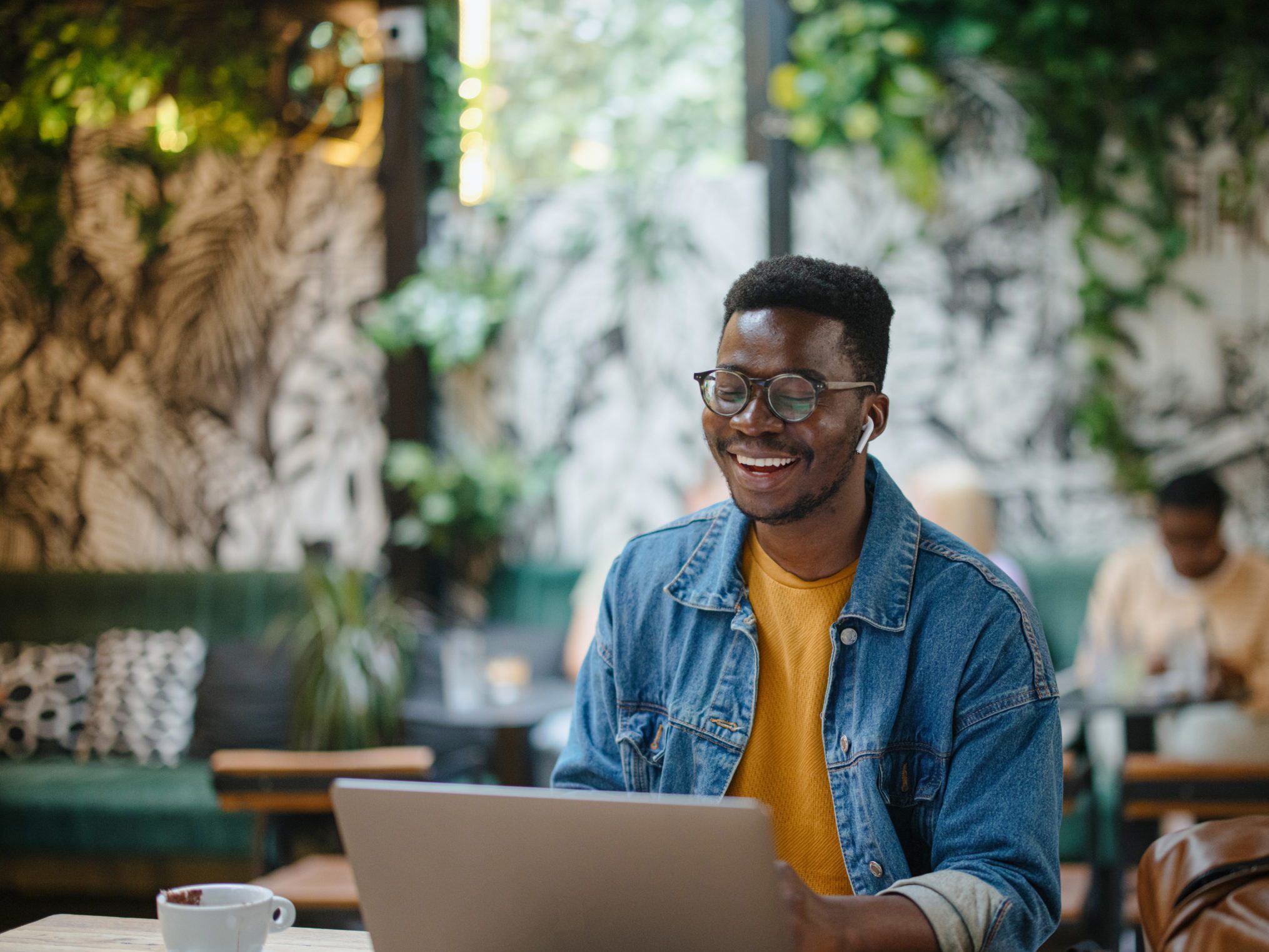 Young man on a video call in a cafe
