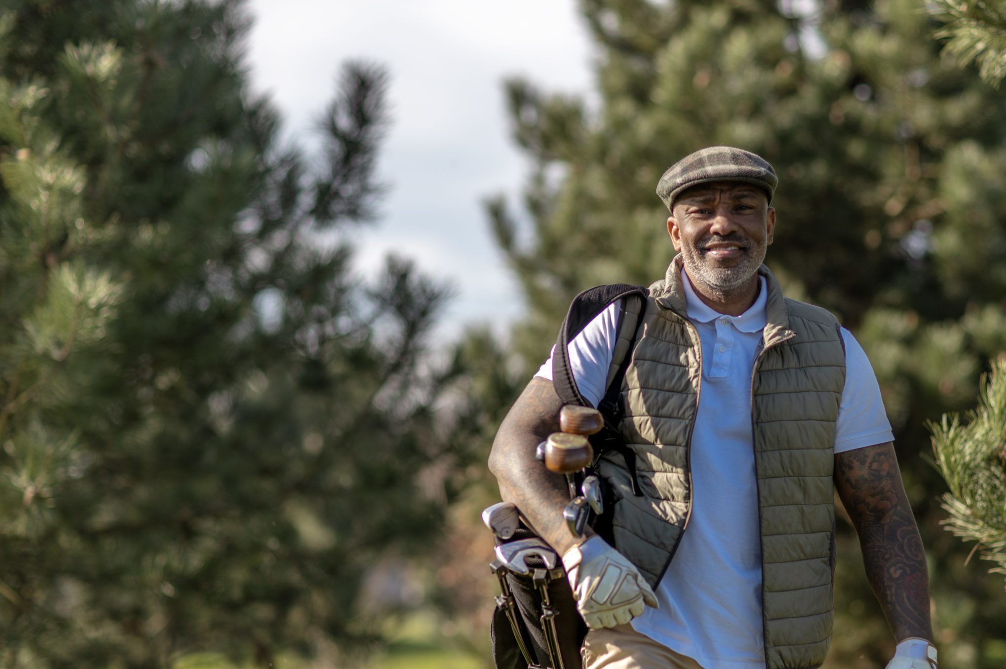 Handsome senior black golfer man enjoying a day of activity on a public golf course in the Netherlands