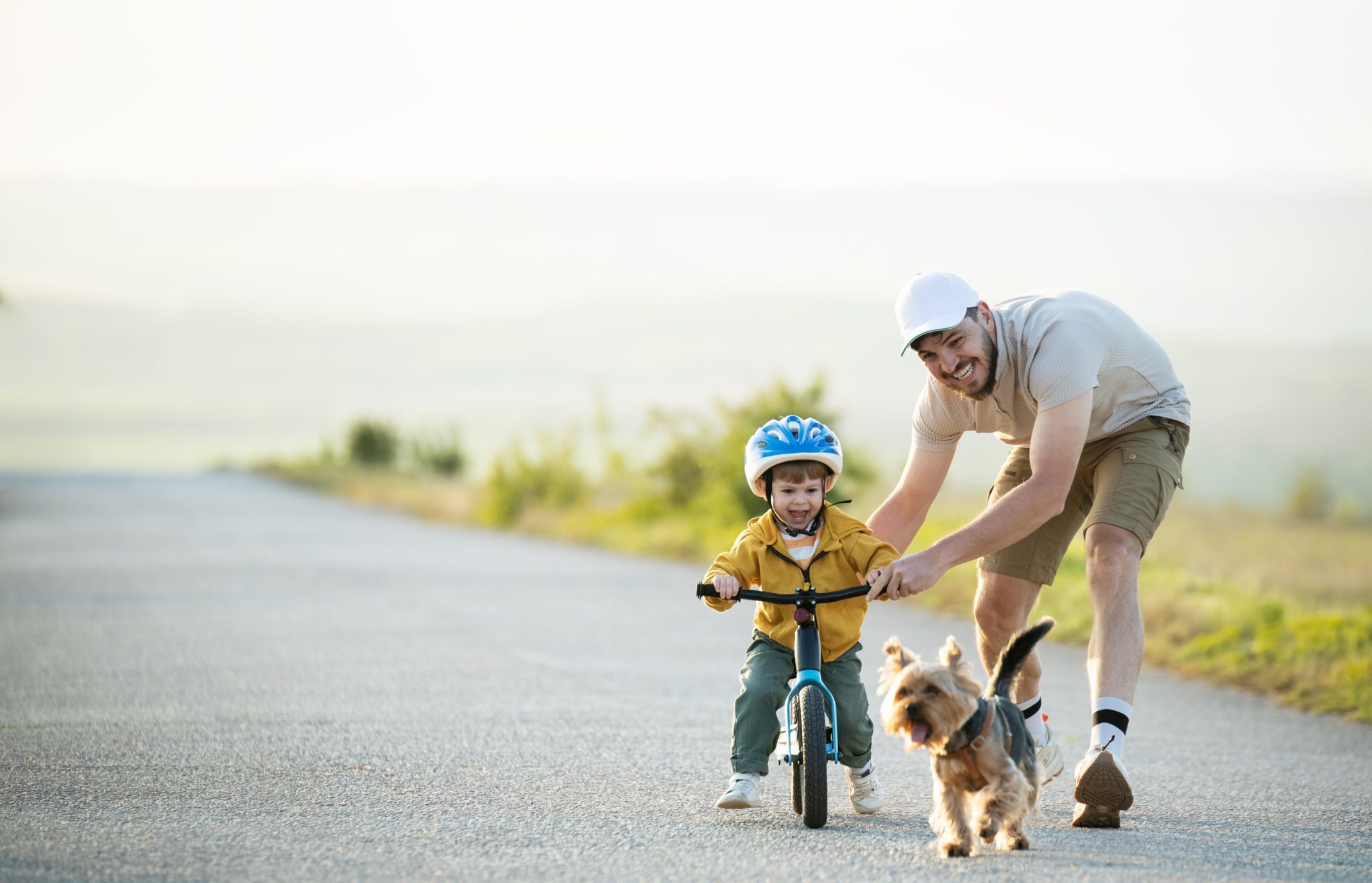 Father teaching son to ride a bicycle