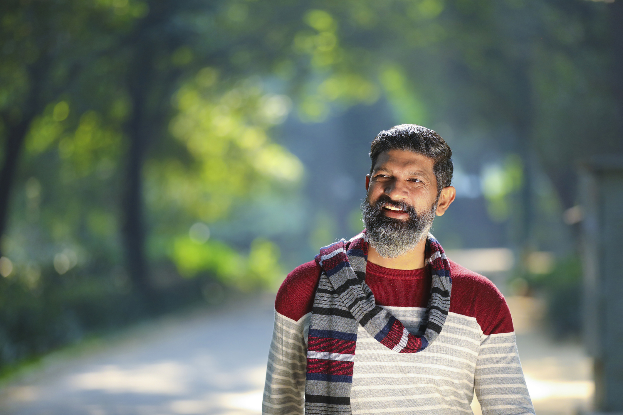 Indian man walking and giving expression at park