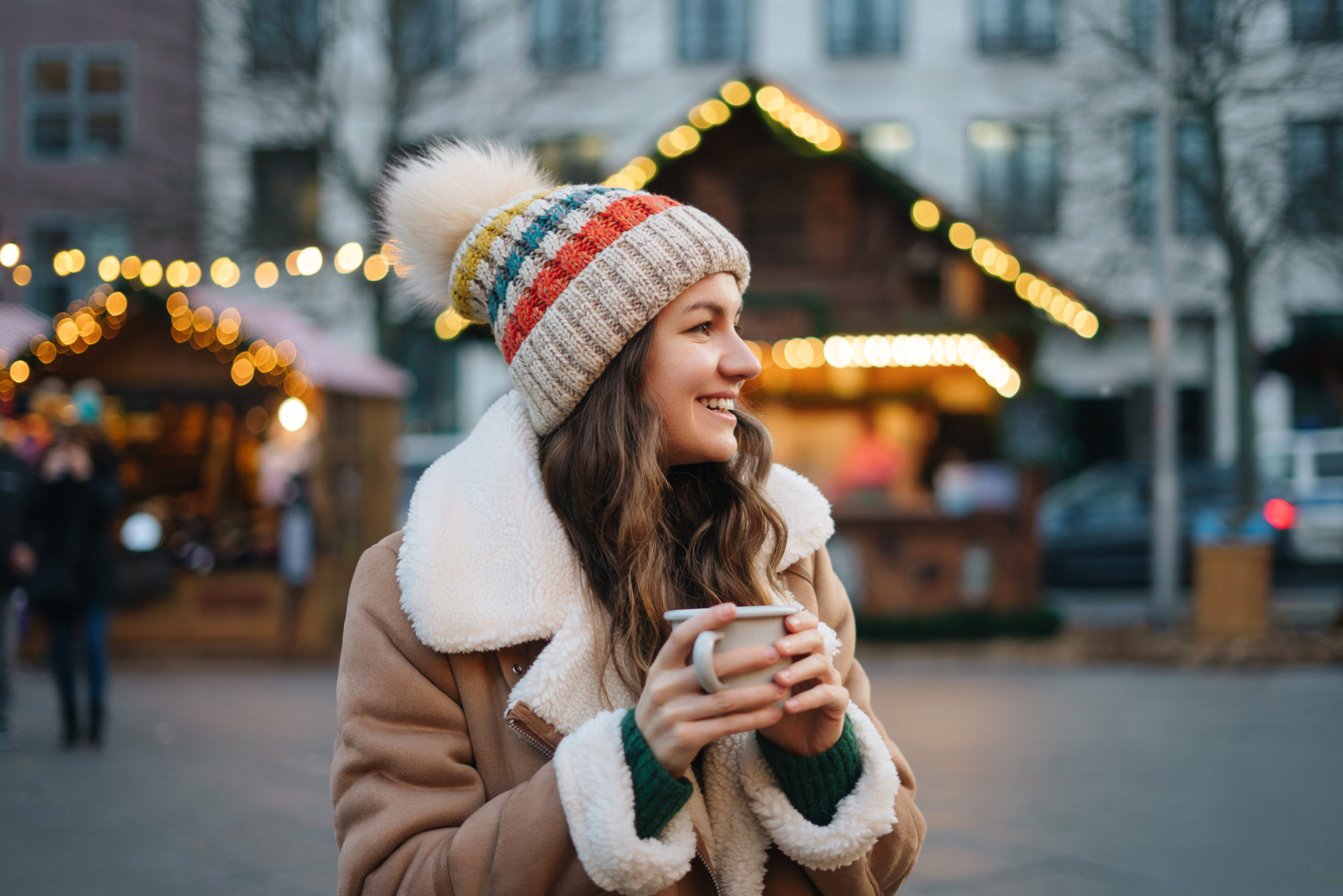 Happy smiling woman  having fun at the Christmas market