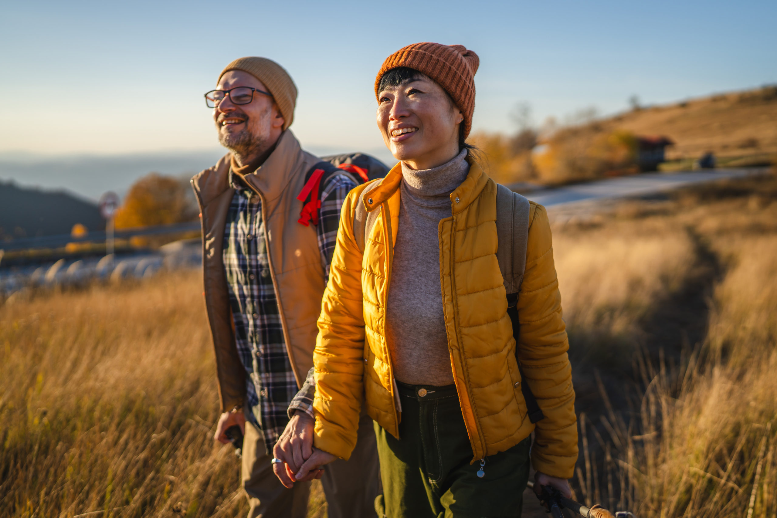 Senior couple hiking holding hands enjoying nature