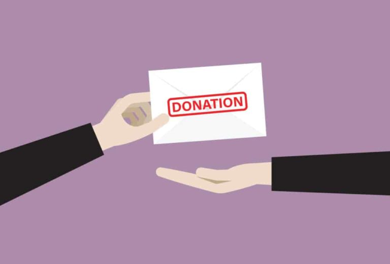 Hand sending a donation envelope